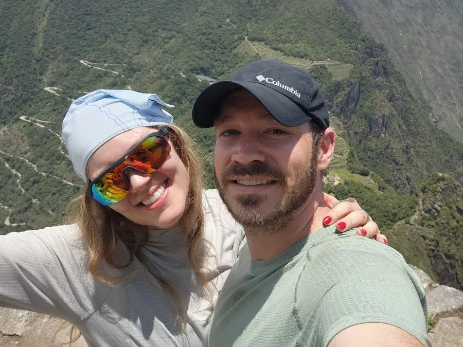 Matthew Dodd and a companion smiling in a selfie on the summit of Huayna Picchu, high above the terraces of Machu Picchu